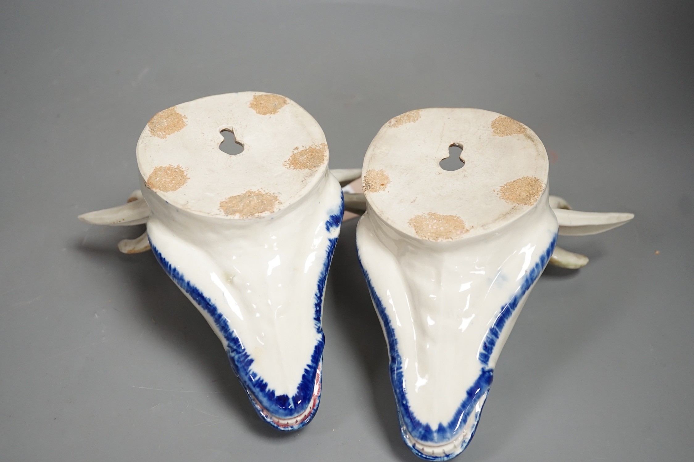 Two Continental pottery stag head wall pockets, 22cms high